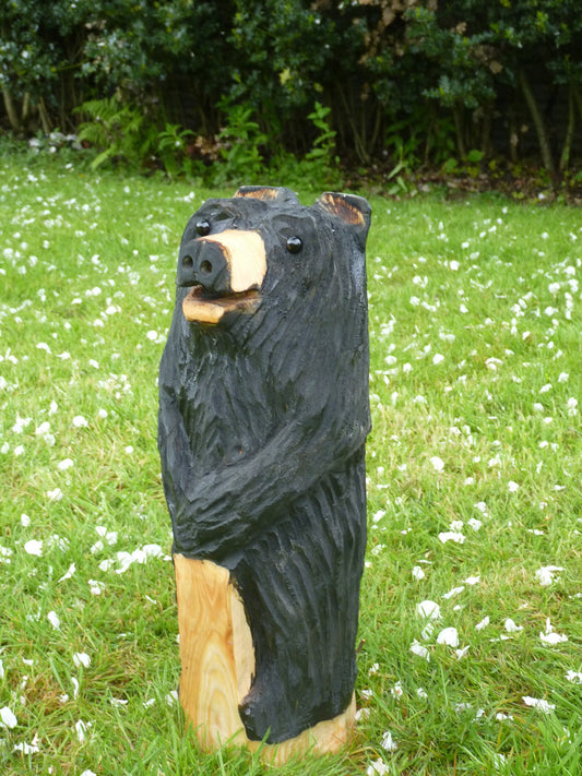 Chainsaw Carved black Bear Standing leaning on a post