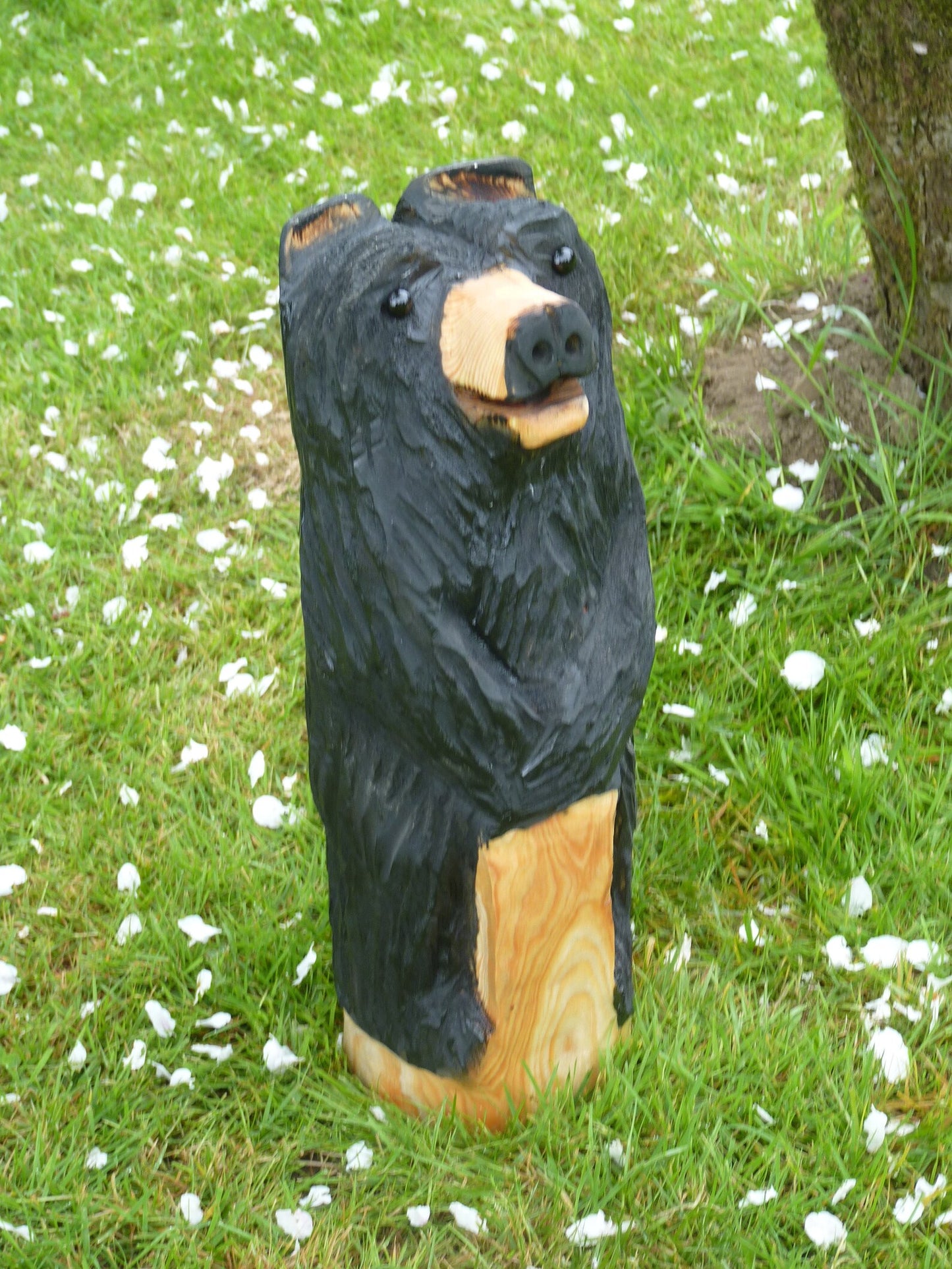 Chainsaw Carved black Bear Standing leaning on a post