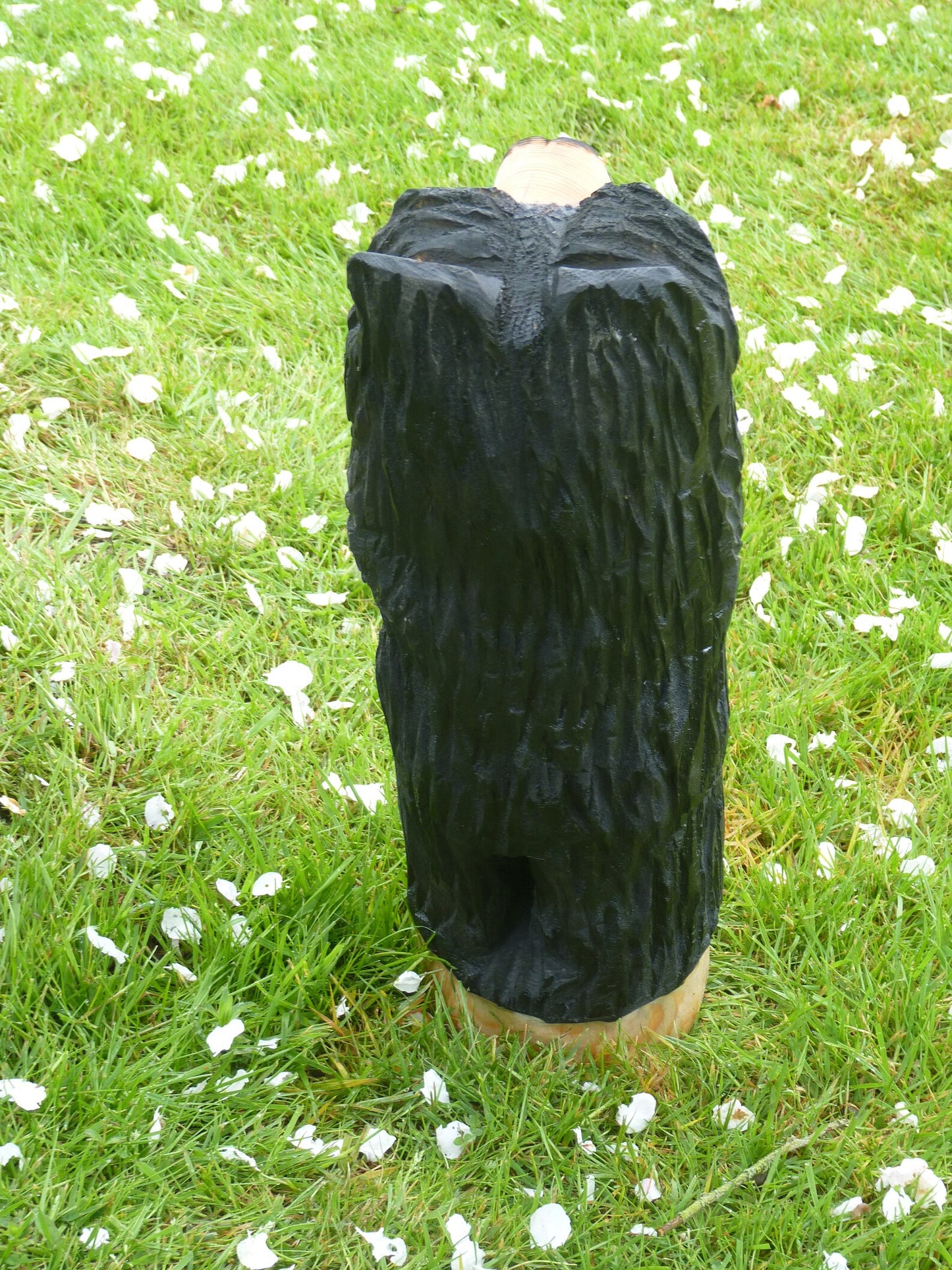 Chainsaw Carved black Bear Standing leaning on a post