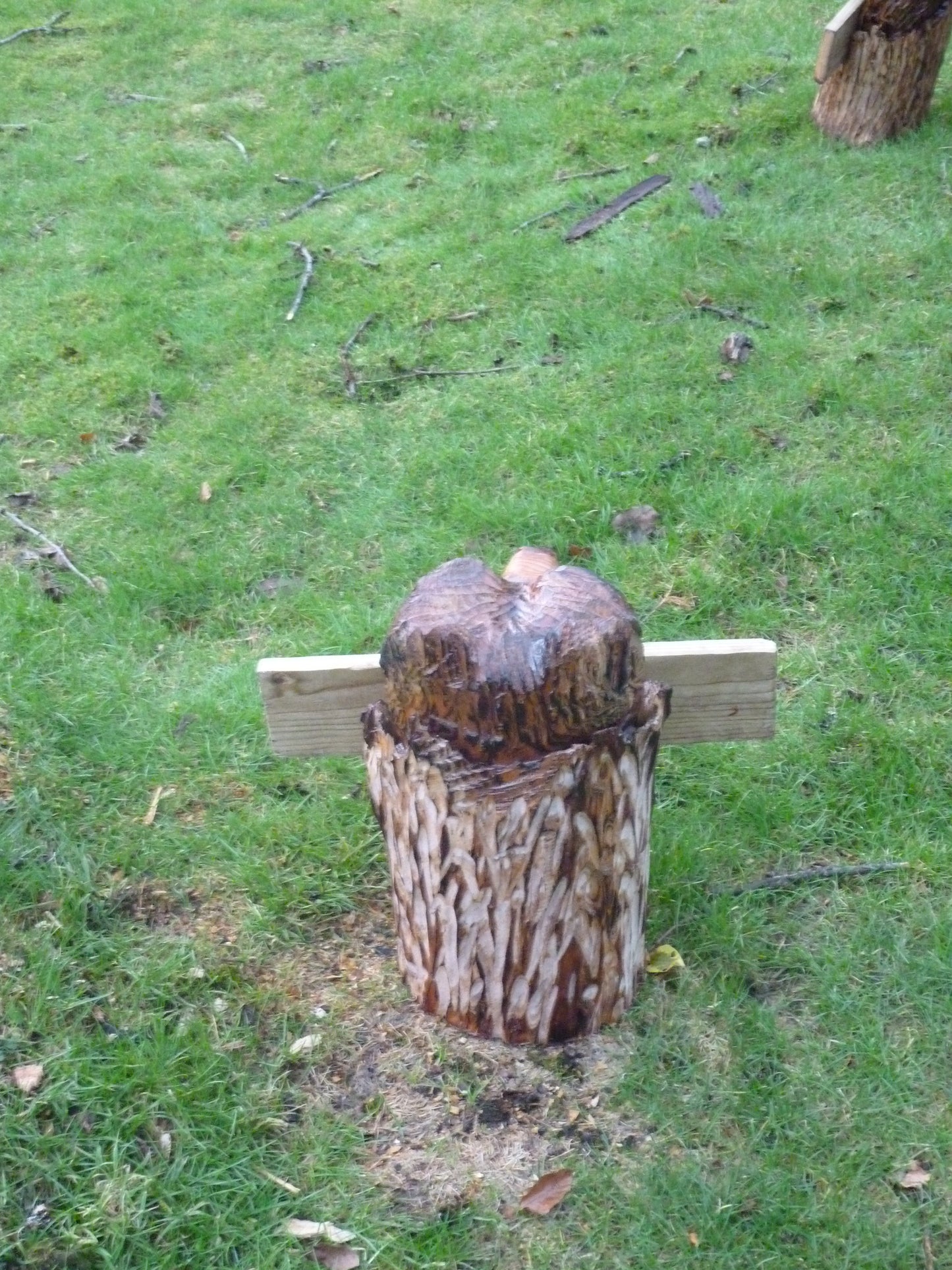 Chainsaw Carved Bear in a log with a welcome sign