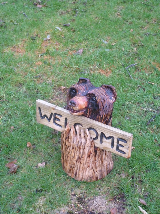 Chainsaw Carved Bear in a log with a welcome sign